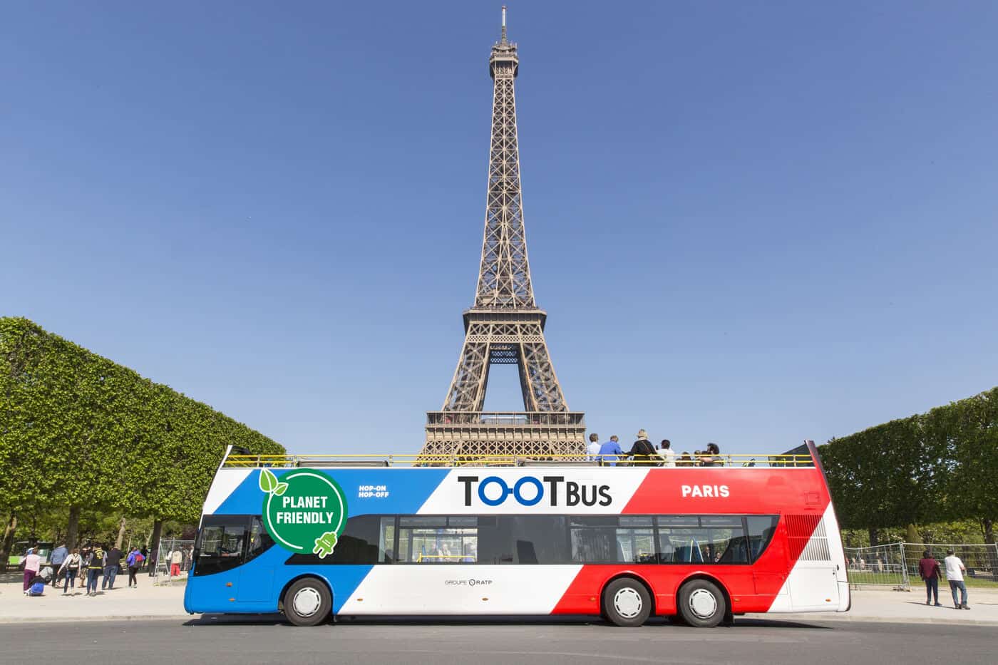 Tootbus Hop-on hop-off bus in front of the Eiffel Tower in Paris