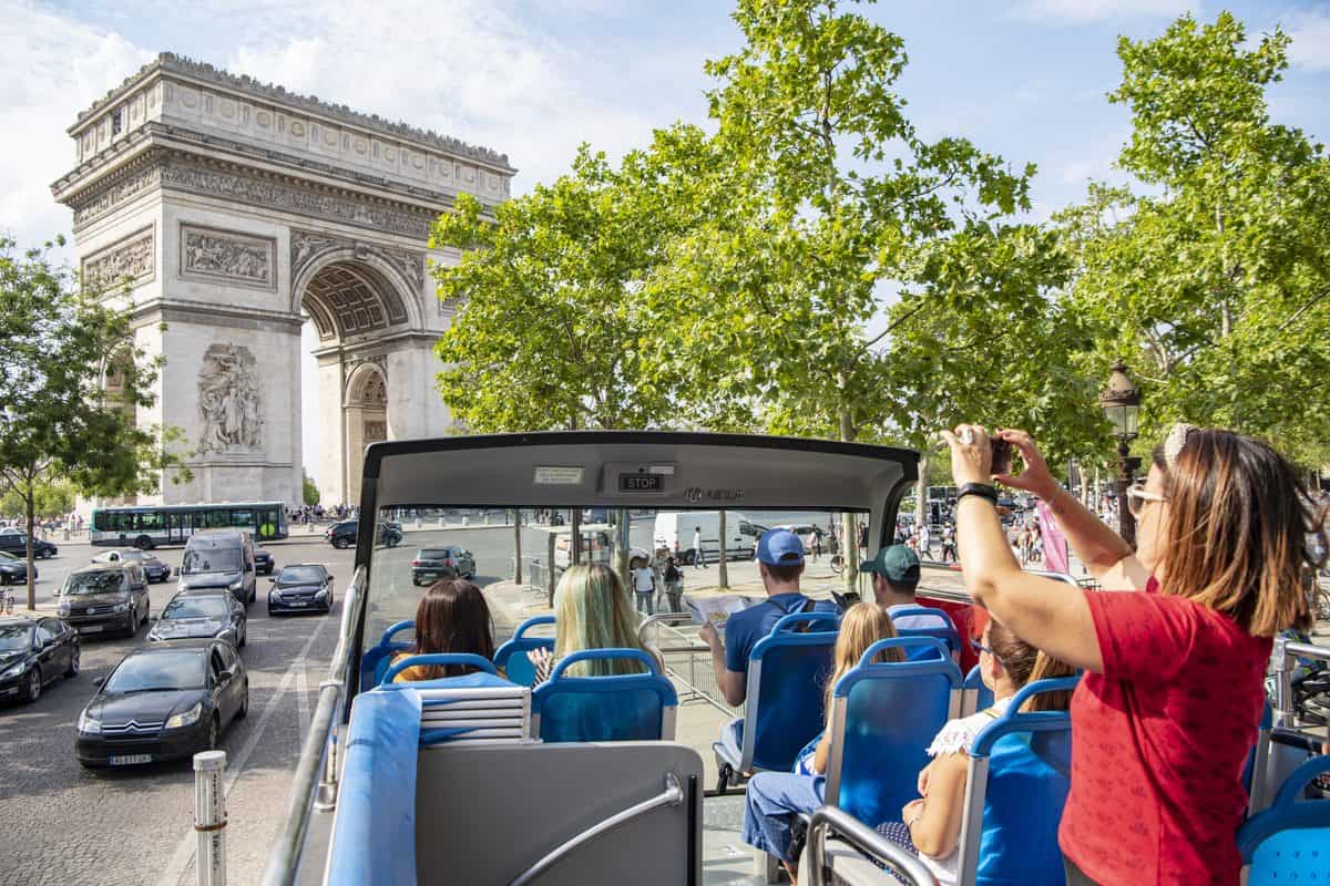 Passagers sur le pont supérieur d'un tootbus à l'Arc de Triomphe