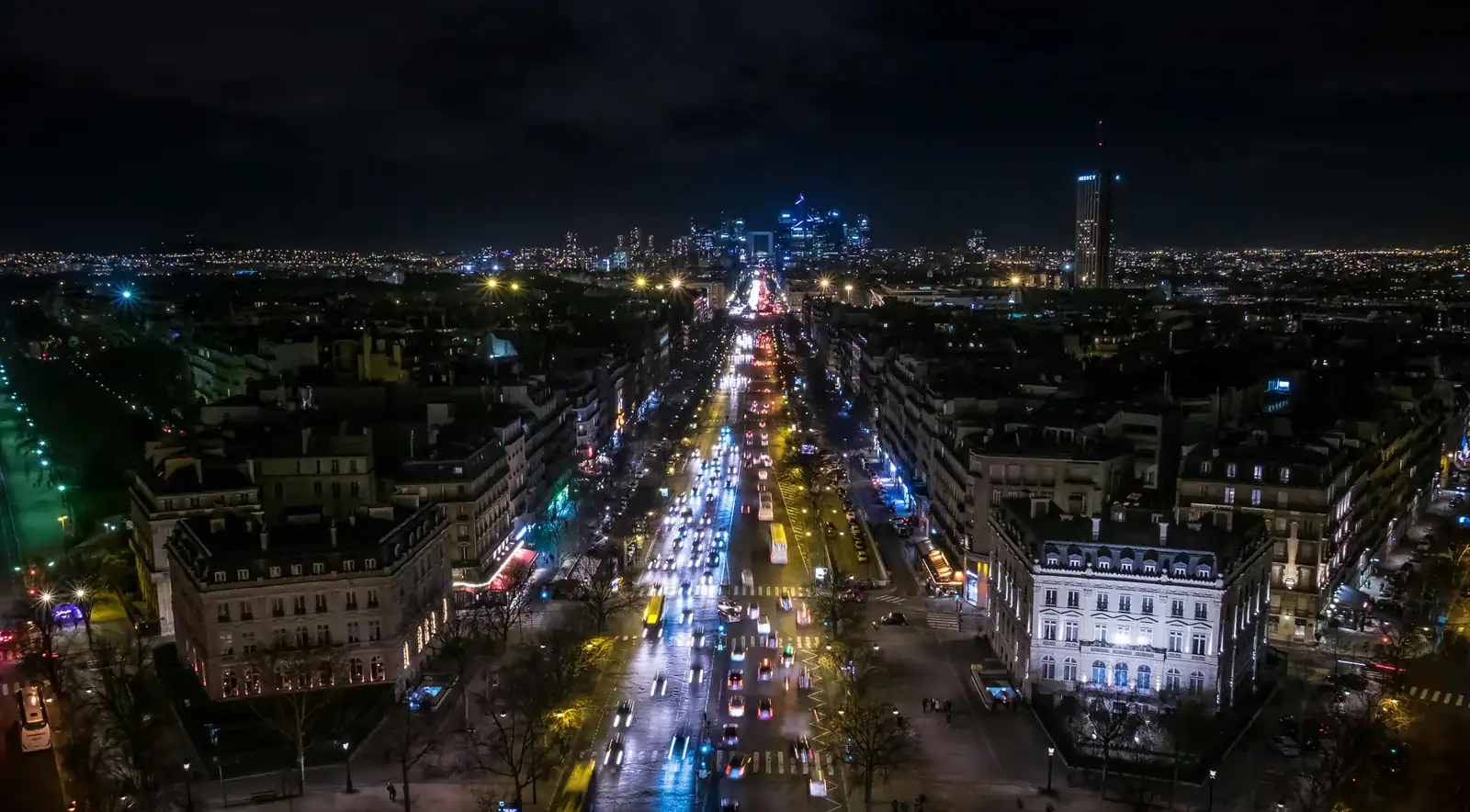 Illuminated avenue with light trails of traffic in the direction of La Défense at night